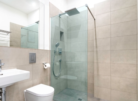 corner walk-in shower in a glass wall