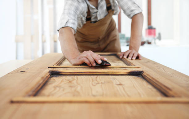 a man is applying sanding to door of closet