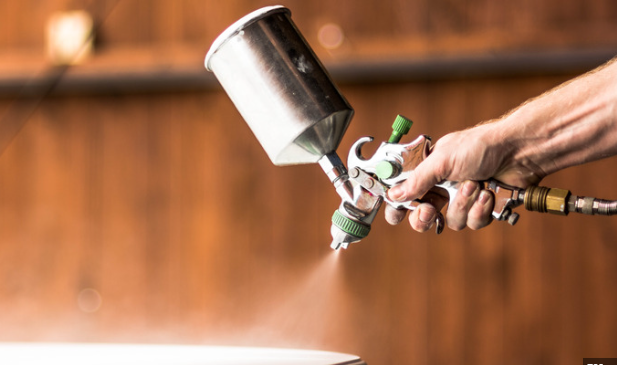 A hand is applying a Protective Sealer spray
