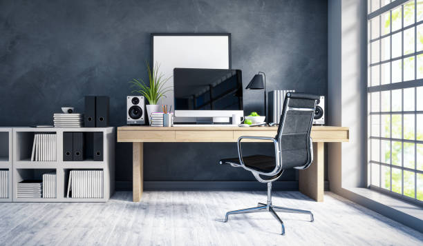 desk with a computer placed against the wall opposite the seating area